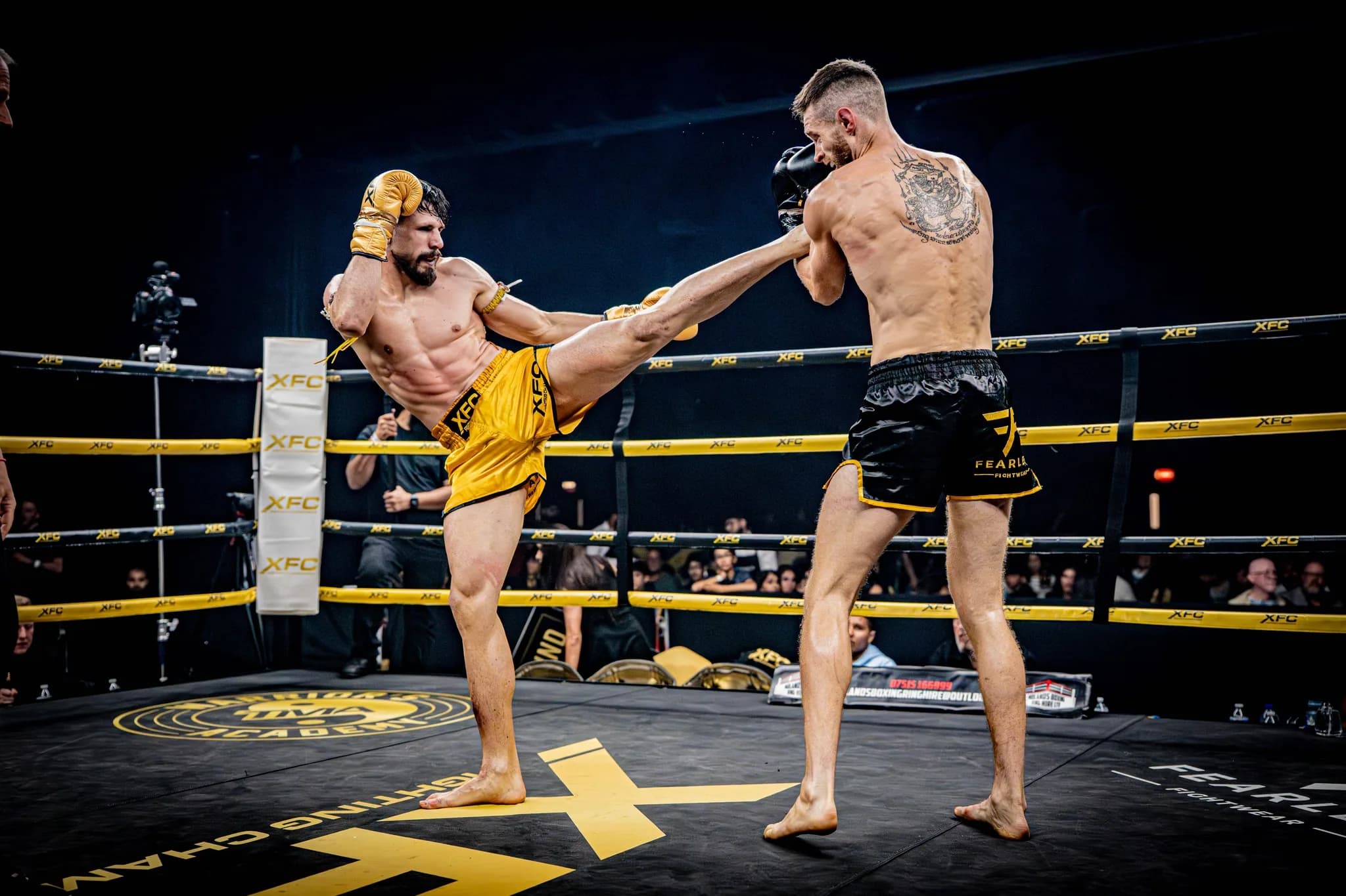 XFC fighter extending a straight kick toward an opponent in the ring.