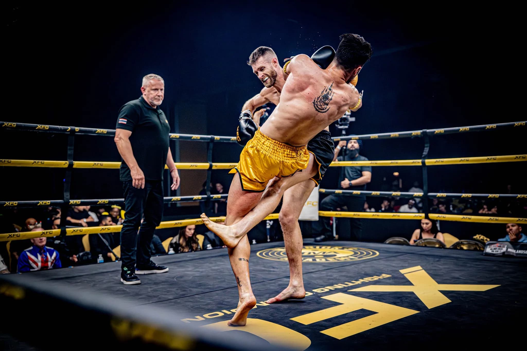 XFC fighter sweeping an opponent's leg during a kickboxing exchange.