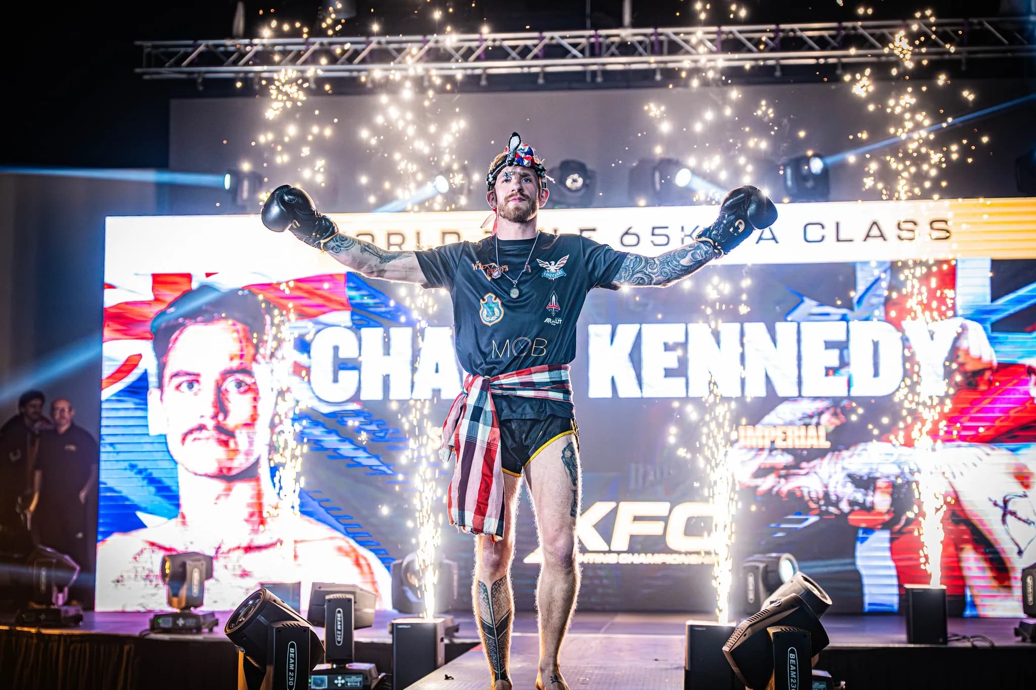 XFC fighter walking out through stage sparks with the venue screen behind him.