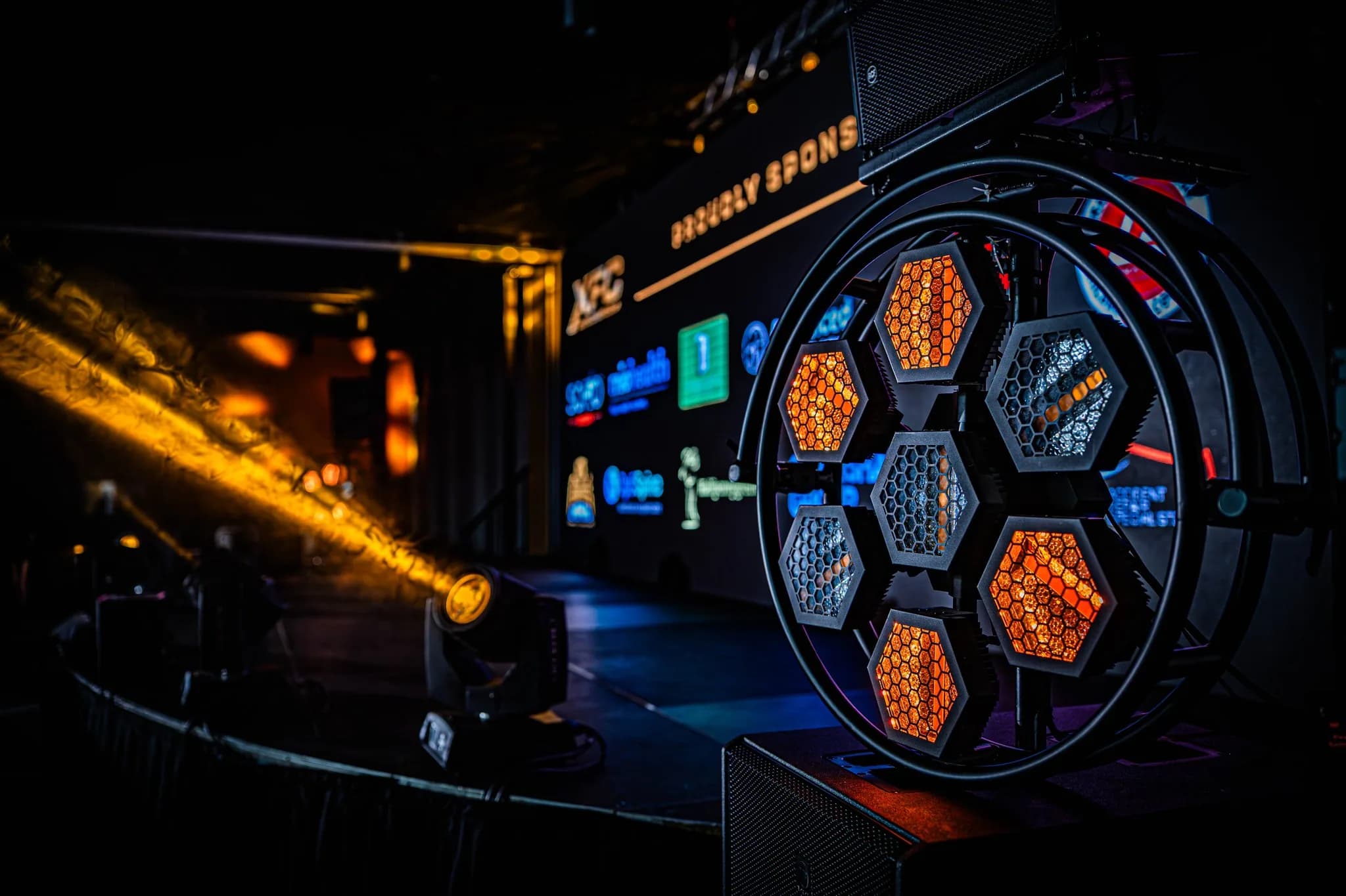 Empty XFC stage lighting rig with warm beams and production fixtures before the event.