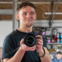 Luke Bolstridge holding a camera, founder and lead photographer, Nottingham.